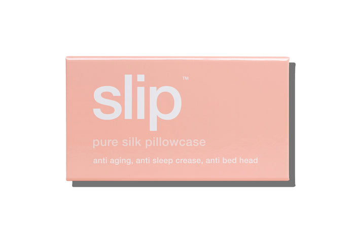 A pink slip silk king pillowcase branded packaging on a white background.