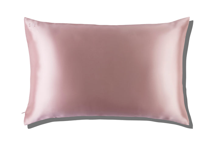 A pink slip silk queen pillowcase on a white background.