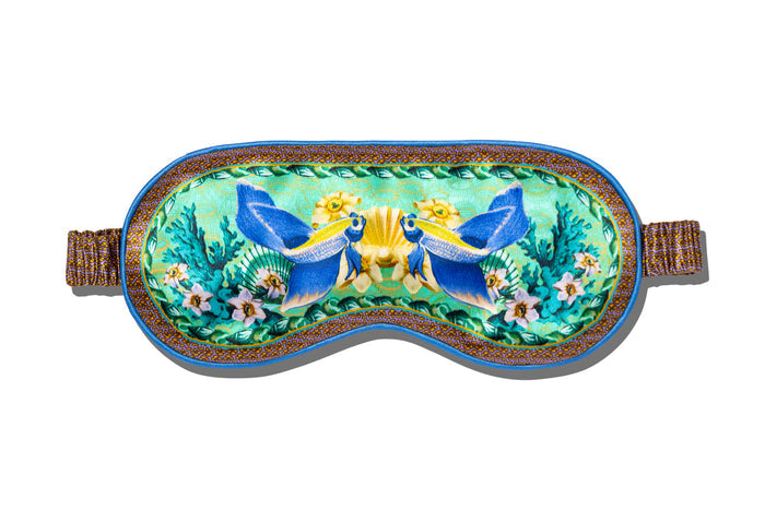 A floral and fish patterned slip silk sleep mask for Pisces star sign with blue, green, and brown colors.