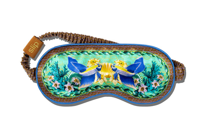 A floral and fish patterned slip silk sleep mask for Pisces star sign with blue, green, and brown colors.