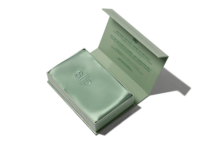 Green Pistachio silk pillowcase in slip packaging on a white background.