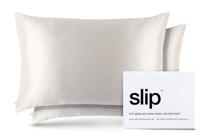 Two white slip silk queen pillowcases with branded packaging on a white background.