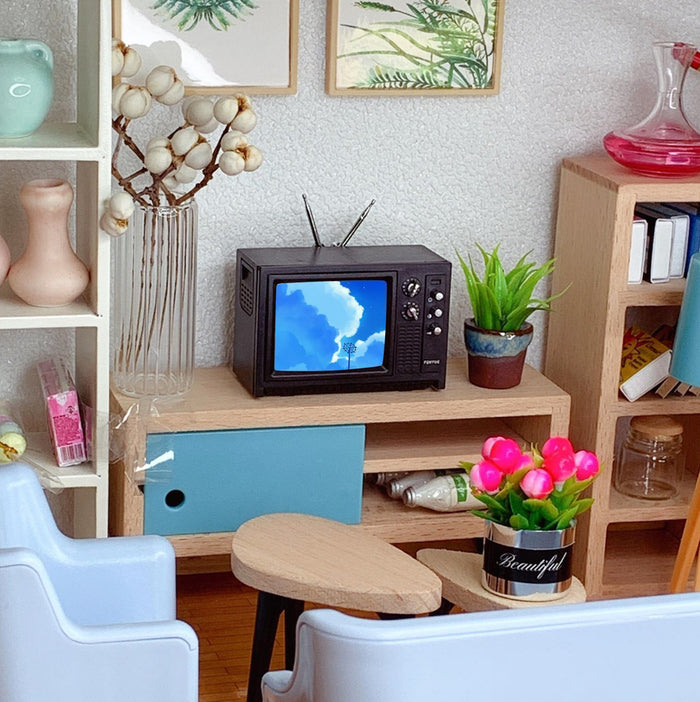 Miniature dollhouse TV in room