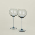 Set of two ribbed blue wine glasses.