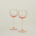 Set of two ribbed blush wine glasses.