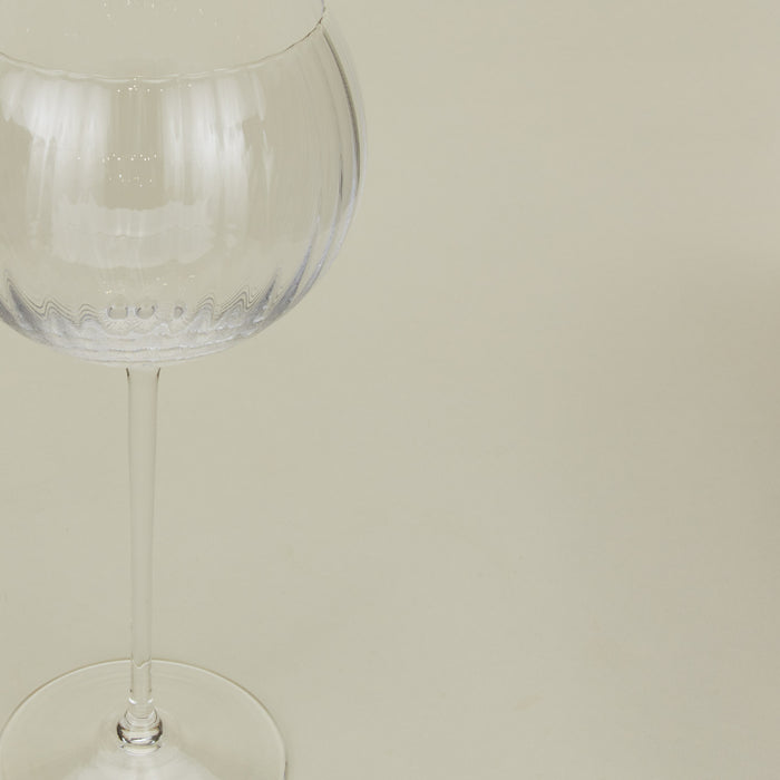 Close up of ribbed clear wine glass.