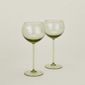 Set of two ribbed olive wine glasses.