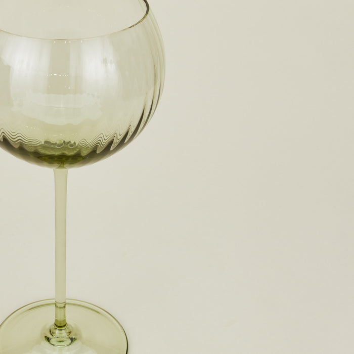 Close up of ribbed olive wine glass.