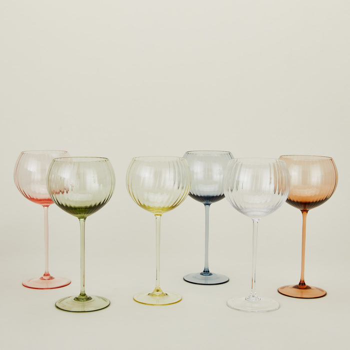 Red wine glasses in a variety of colors.