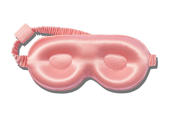 A rose slip silk contour sleep mask designed to protect delicate eyelash extensions, on white background.