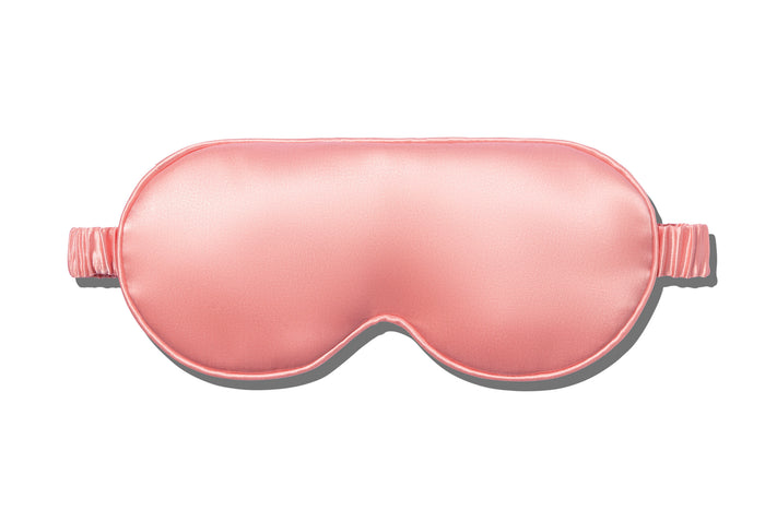 A rose slip silk contour sleep mask designed to protect delicate eyelash extensions, on white background.