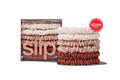 Stack of white, desert rose and dusk skinny silk scrunchies with the brand name 'SLIP' visible on the packaging.