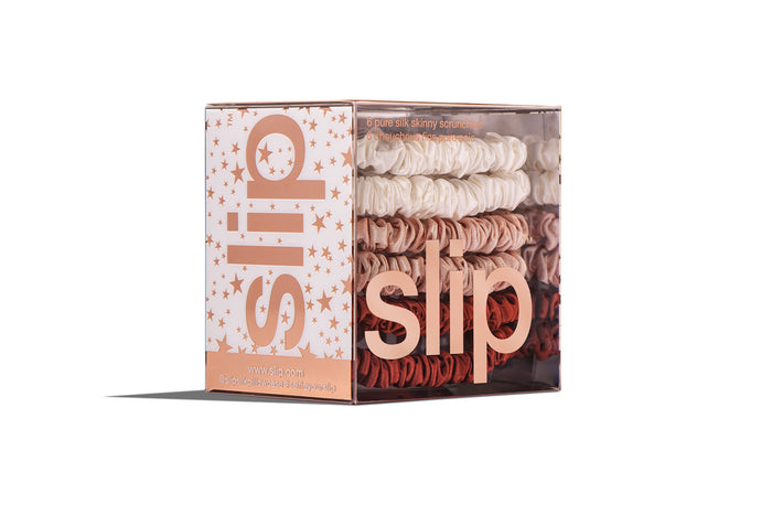 Rose star silk skinny scrunchies in slip packaging with rose gold stars on a white background.