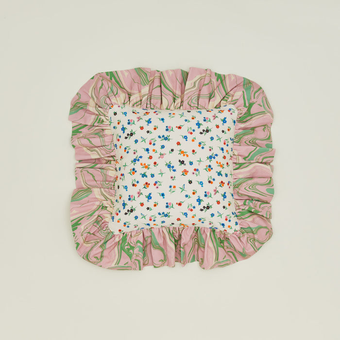 A ruffled floral cushion with a peony pattern.