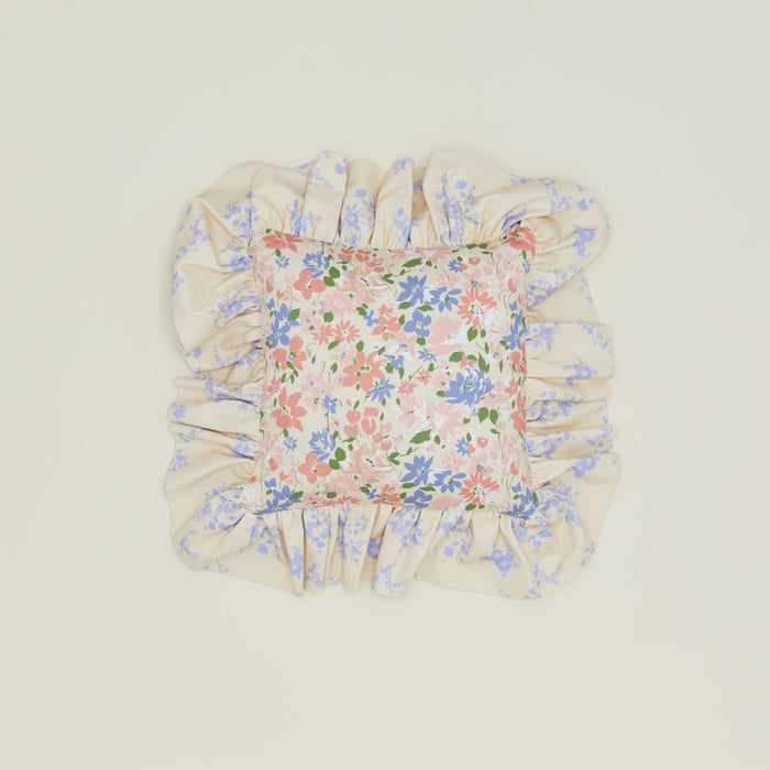 A ruffled floral cushion with a rose pattern.