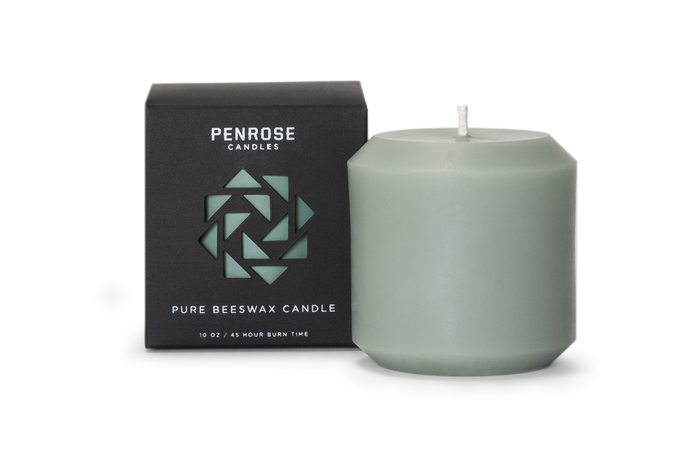 A green 3 inch pillar candle made from pure beeswax, displayed next to its packaging box with the brand name 'Penrose' and the product type 'Pillar Candle' indicated.