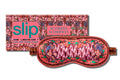 A silk sleep mask with a scorpion pattern, predominantly in pink, red and purple shades, displayed alongside its packaging which has 'slip' and 'SCORPIO' text.