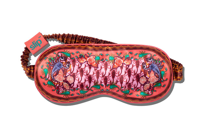 A slip Scorpio silk sleep mask with a scorpion pattern in red and purple shades on a white background.
