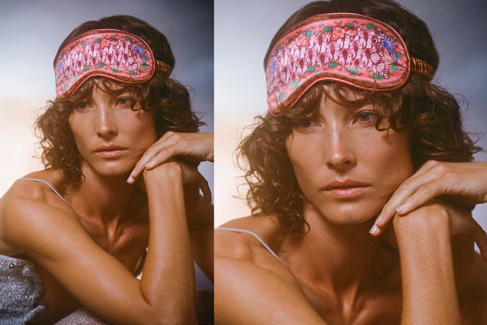 A woman wearing a slip silk sleep mask with a scorpion pattern.