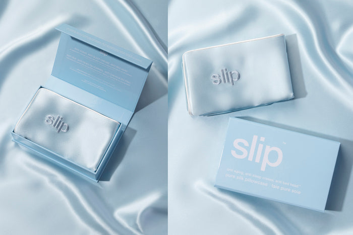A seabreeze blue slip silk queen pillowcase with an invisible zipper closure. Displayed in open branded box with seabreeze blue background.