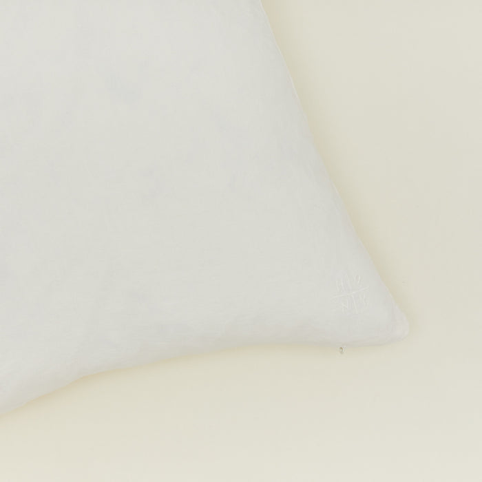 Close up view of simple linen pillow in ivory