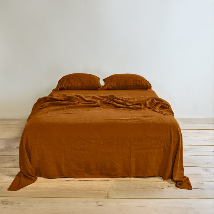 Simple linen bedding in terracotta