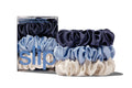 Set of blue, white, and navy large scrunchies with packaging labeled 'slip' on a white background.