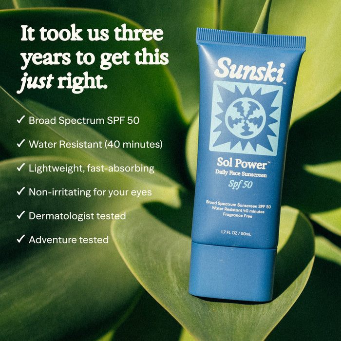 Sunski Sol Power sunscreen tube on a leafy green background with product features listed.