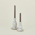 Large and small splatterware candlesticks in white and grey with candles