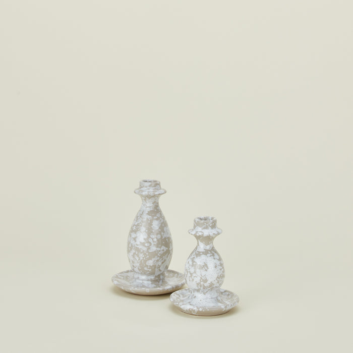 Large and small splatterware candlesticks in white and grey