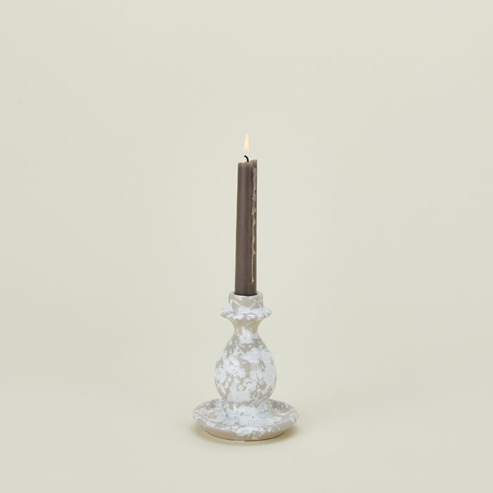 Small splatterware candlestick in white and grey with candle
