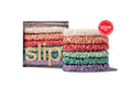 A set of colorful silk skinny scrunchies by Slip brand with packaging on white background.