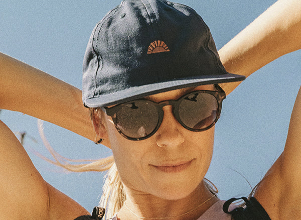 RICH close up of woman's face wearing sunski sunburst hat