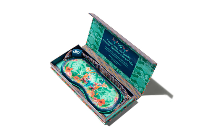 Taurus pure silk sleep mask with floral patterns, predominantly in blue, green and orange in slip packaging.