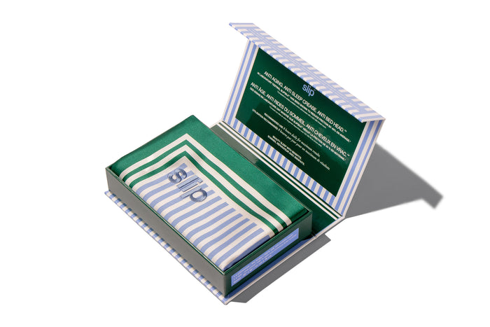 Striped slip silk pillowcase in open packaging on a white background