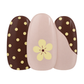 Toast & Honey gel nail sticker by Maniac Nails, cream nail with brown dots and a small flower