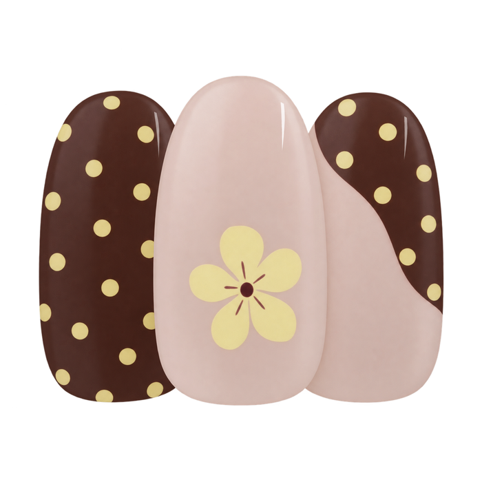 Toast & Honey gel nail sticker by Maniac Nails, cream nail with brown dots and a small flower