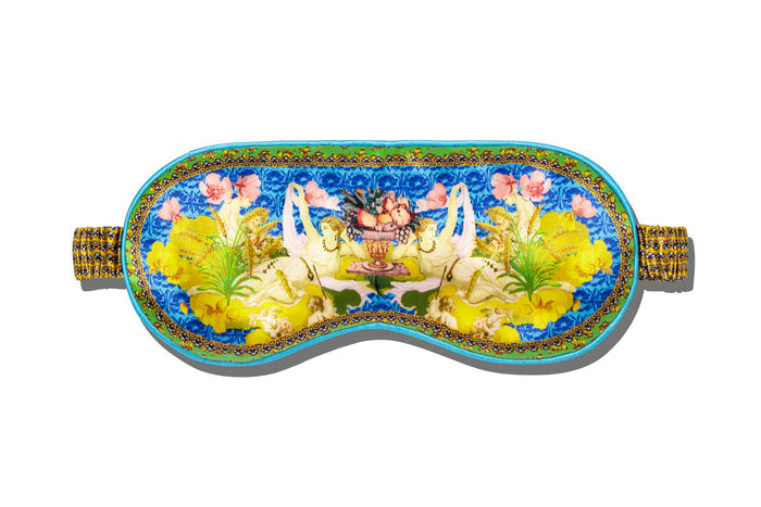 Virgo pure silk sleep mask with floral patterns, predominantly in yellow, green and blue, on a white background.
