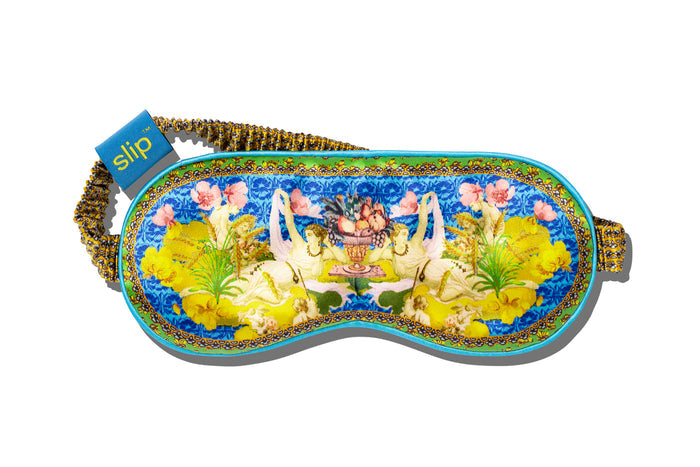 Virgo pure silk sleep mask with floral patterns, predominantly in yellow, green  and blue with a slip tag.
