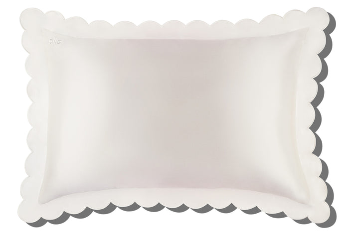 A white pure silk slip queen pillowcase with scalloped edge and invisible zipper closure white background.