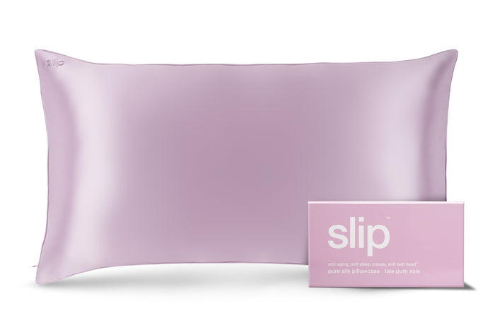 A lilac slip silk king pillowcase with branded packaging on a white background.