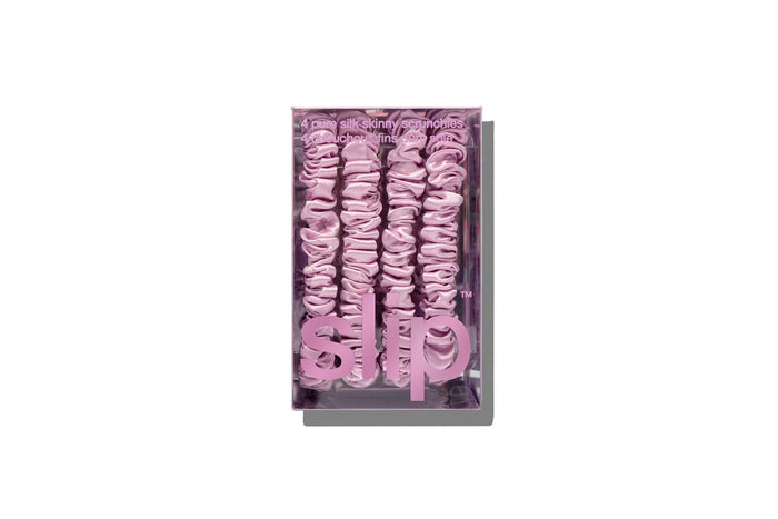 Lilac silk skinny scrunchies in slip packaging on a white background.