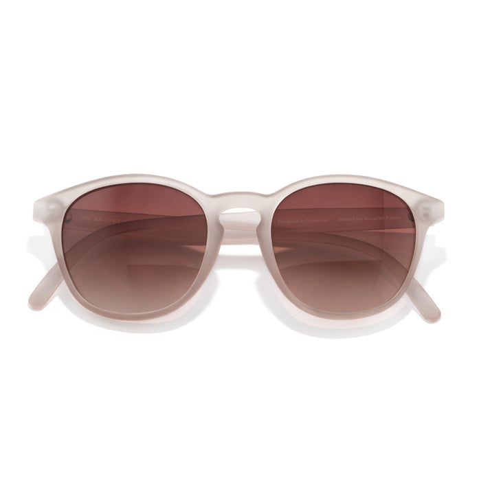 Sunglasses with white frame and brown gradient lenses on a white background
